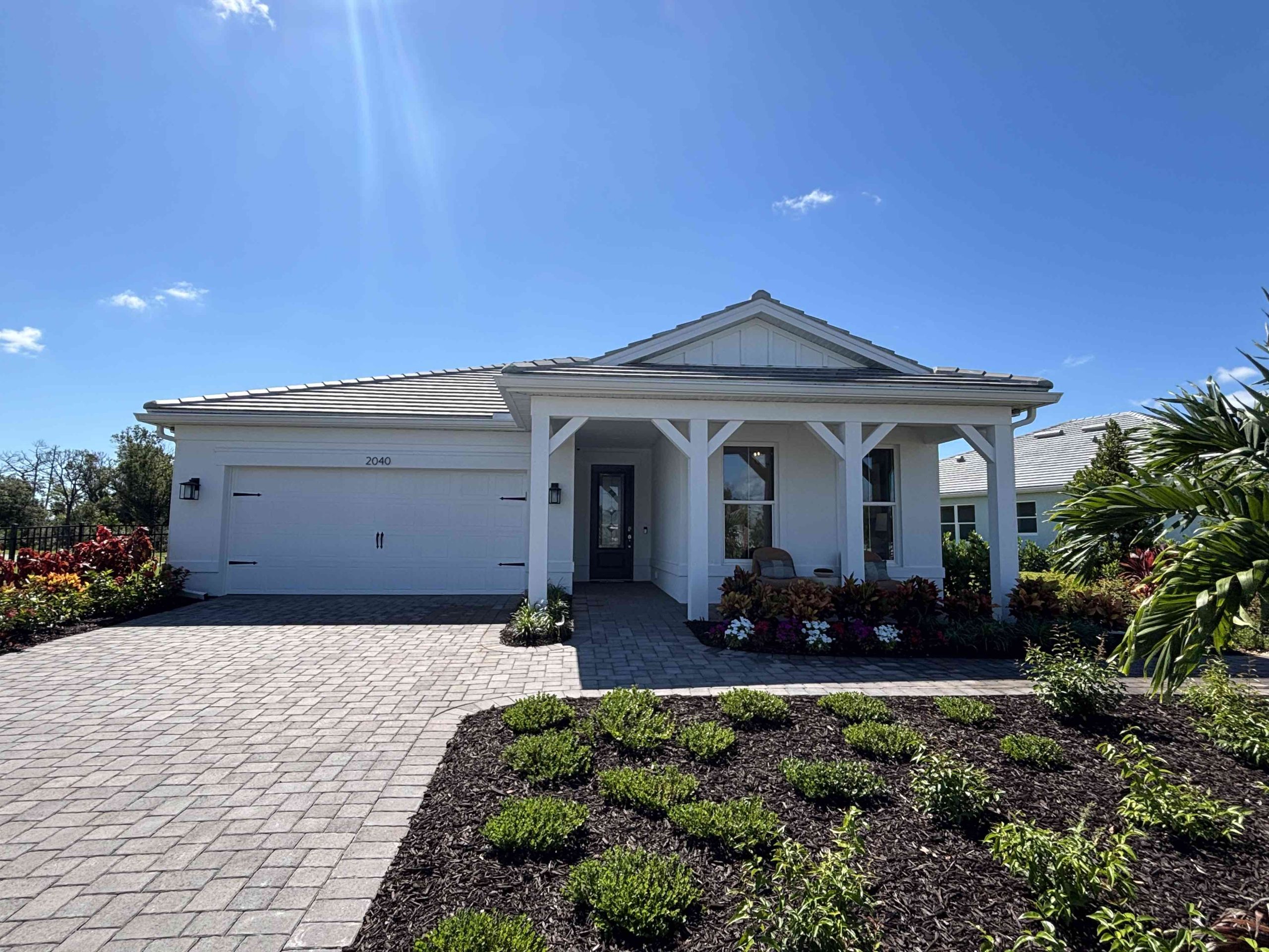 palmary model home front with driveway and landscaped garden