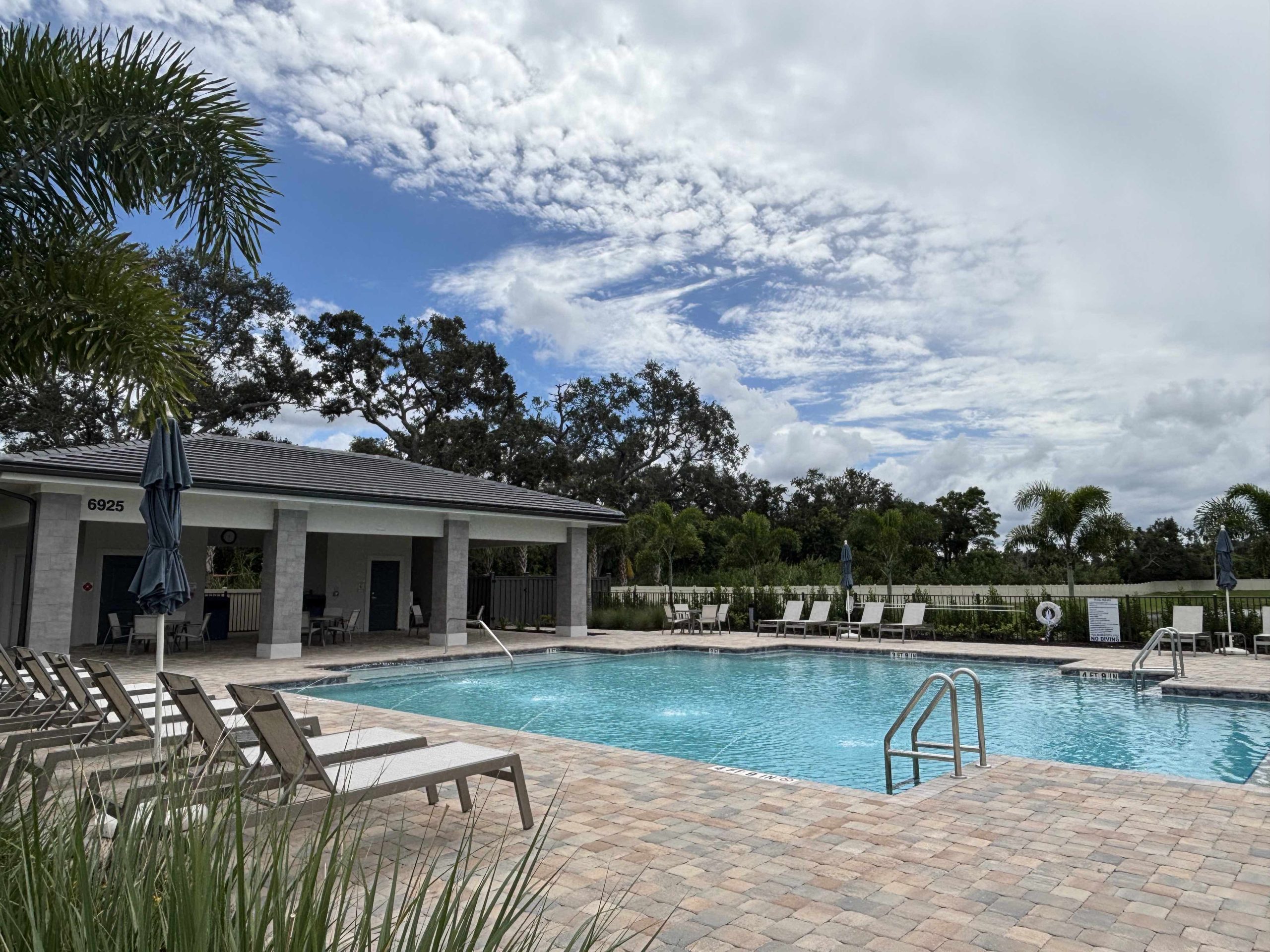 community pool with cabana in the florida sunshine