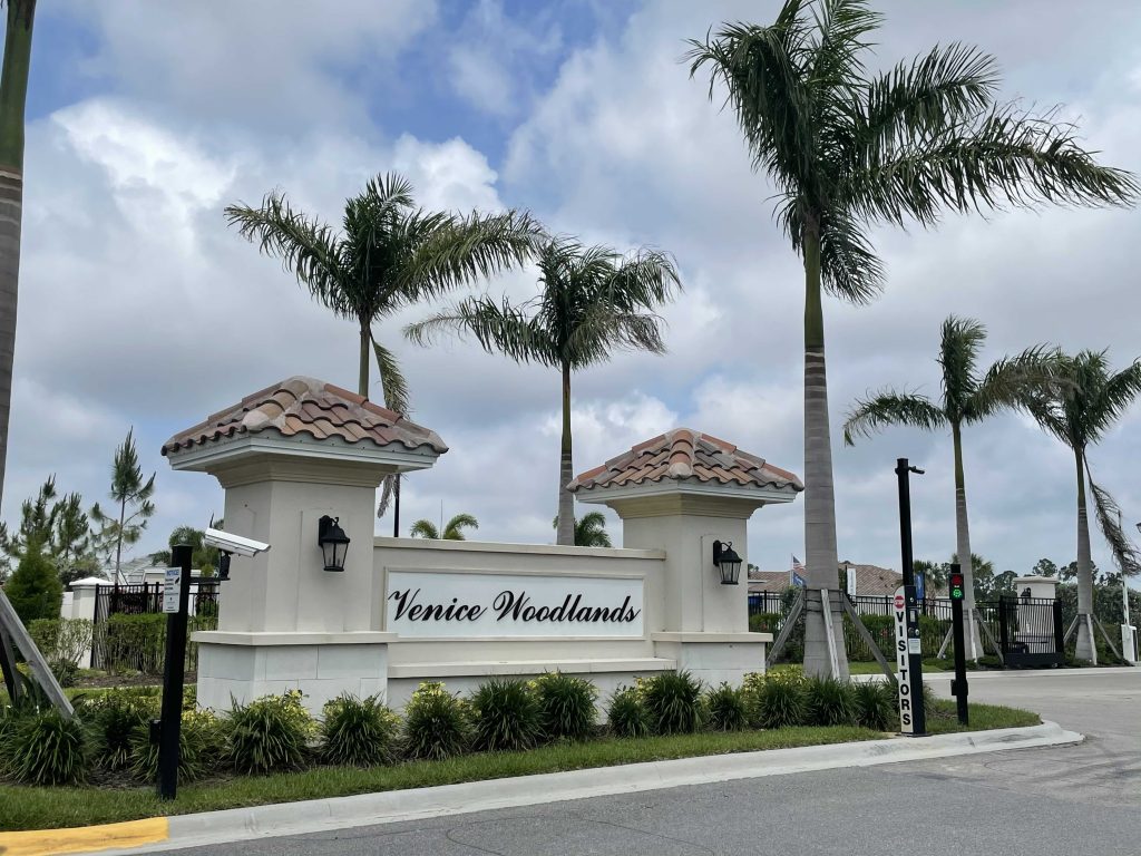 venice woodlamd entrance sign - a no cdd fee community in venice, florida