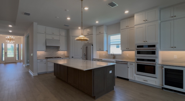 Wellen Park Builders: Your BEST Guide to New Construction Builders & Resale Home Communities 19 Inside kitchen living area of lazio ii home model by taylor morrison in new esplanade at wellen park community new construction wellen park builders