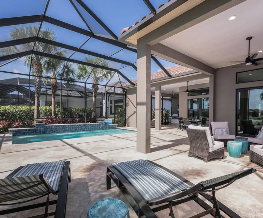 lanai area with covered pool, outdoor seating, and decorative plants