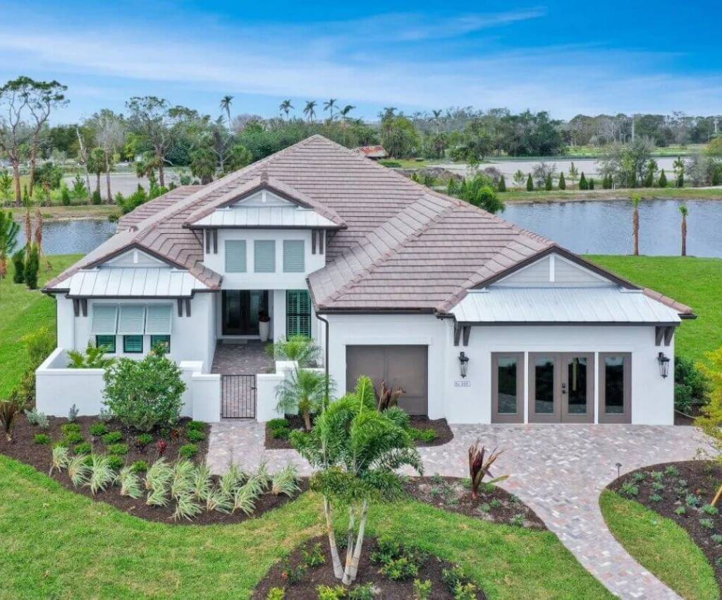 front exterior of the ravenna model by neal signature homes, built on a spacious green lot with lake views