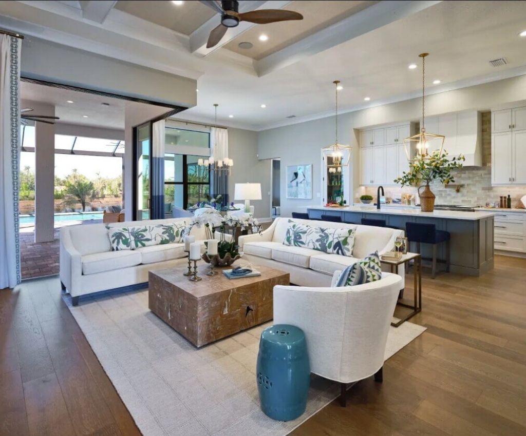open plan loiving-kitchen area with overhead spot lights, full length glass windows and sliding doors, and an airy homely feel.