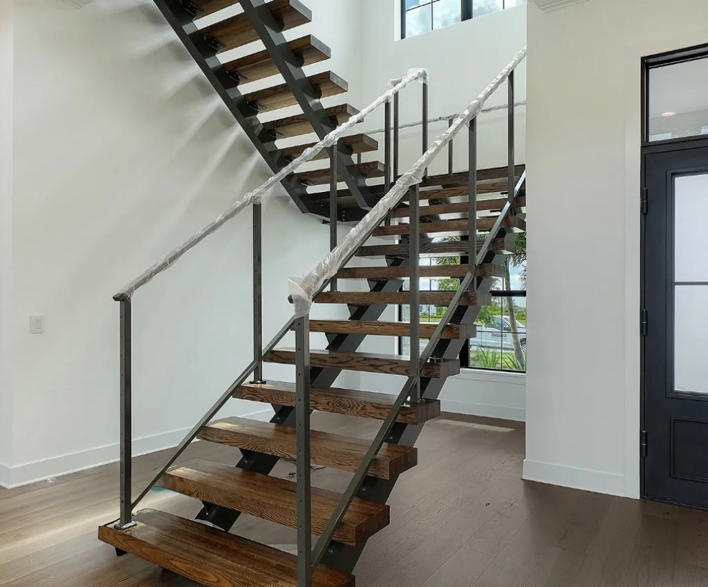 unique wooden staircase features as a design feature from the ground floor to the mezanine above
